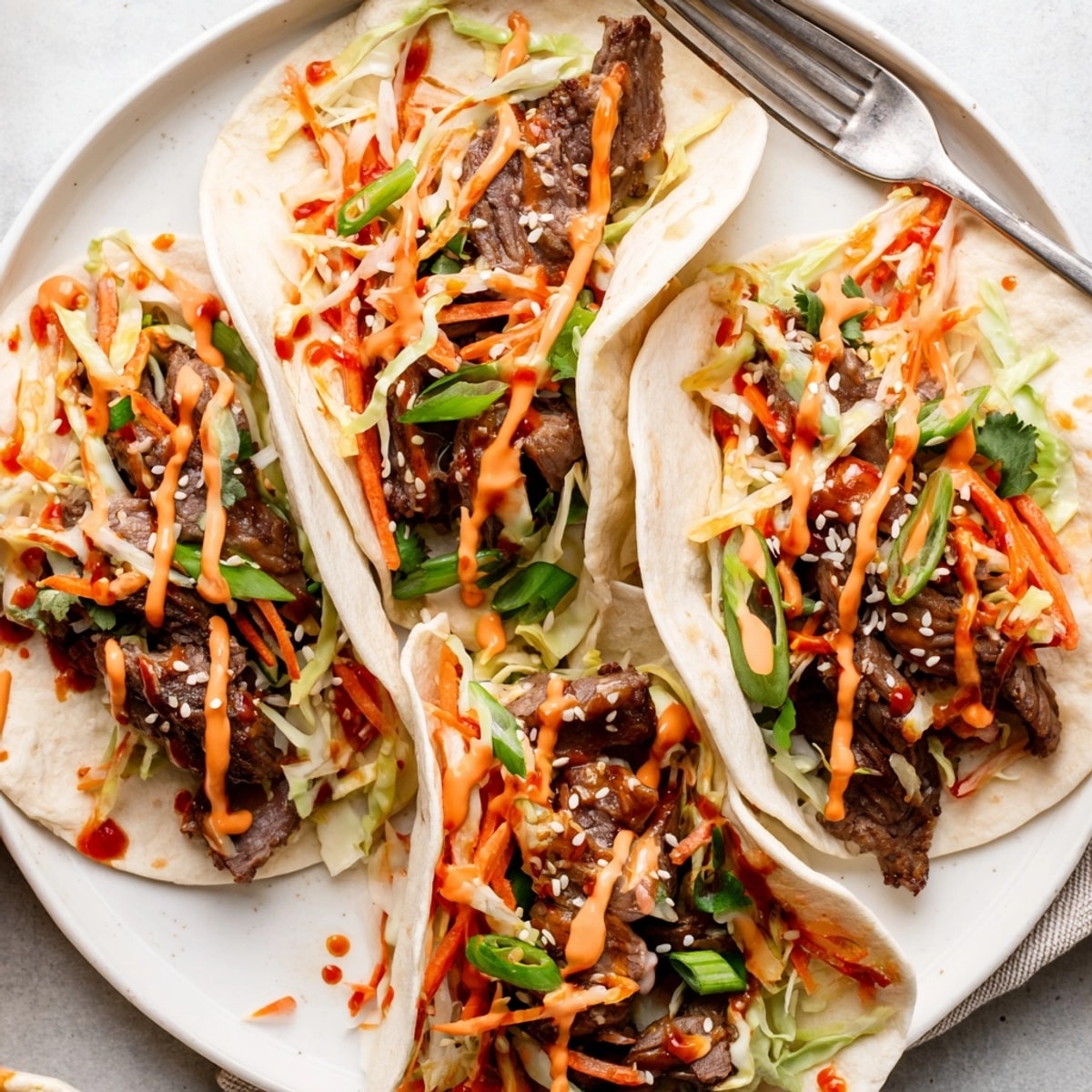 Savory Korean BBQ Tacos recipe: Grilled beef nestled in warm tortillas with spicy slaw.