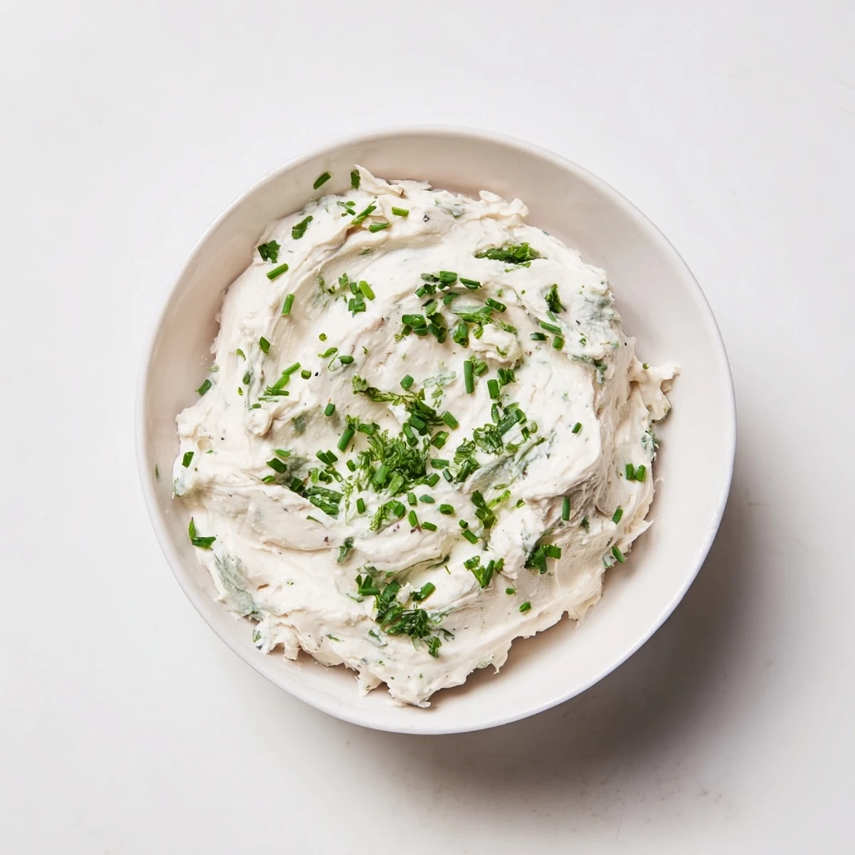 Close-up of creamy dip with fresh herbs, ideal for dipping vegetables; a simple, flavorful appetizer.