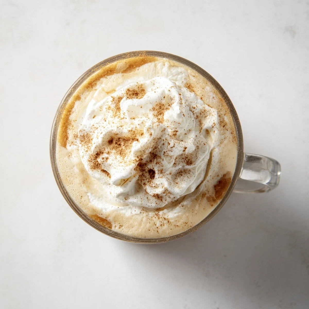 Steaming Spiced Latte topped with whipped cream, cinnamon, and nutmeg; perfect for a chilly day.