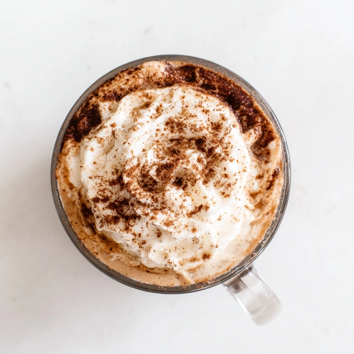 Homemade Spiced Latte: creamy and rich, with warm brown tones of cinnamon and nutmeg sprinkled on top.