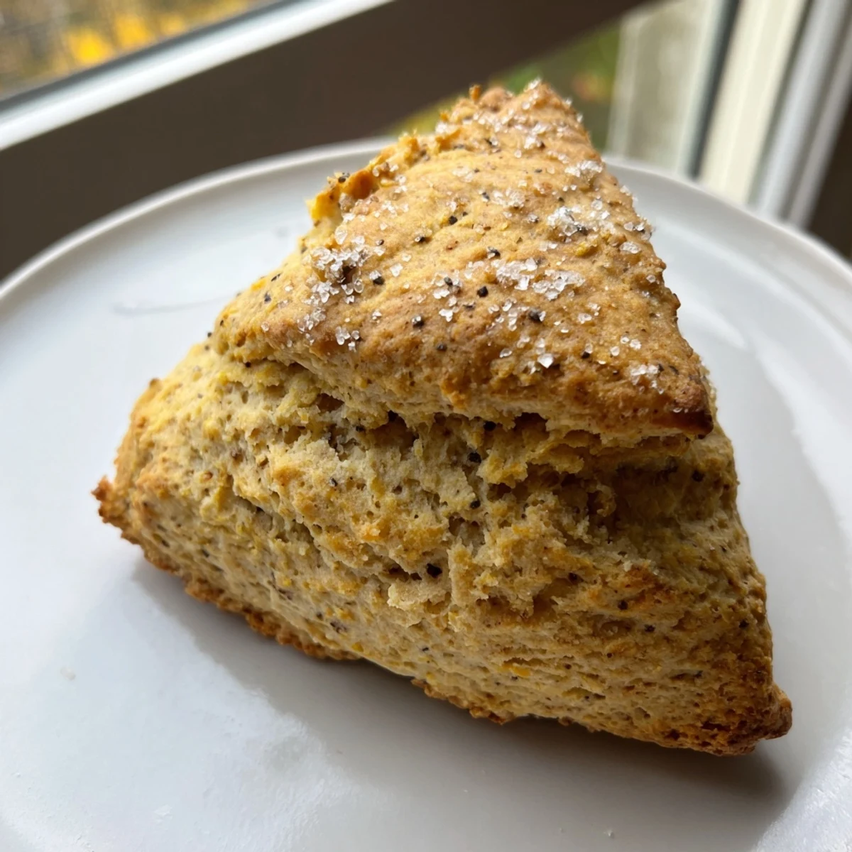 Enjoy fragrant Spiced Chai Tea Scones with a crunchy sugar topping, showing off their delicious flavors and aroma.