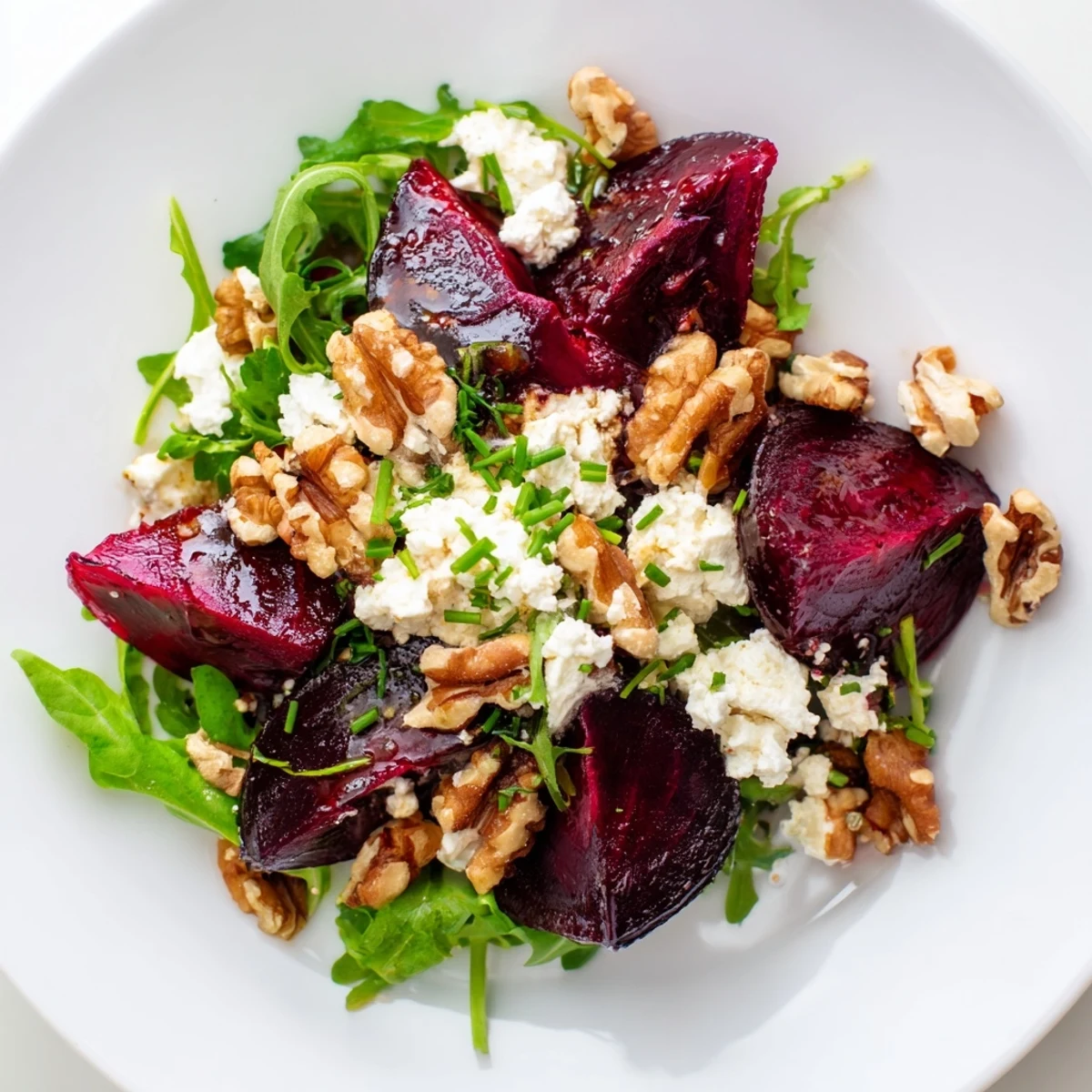 Enjoy a delicious serving of Roasted Beet and Goat Cheese Salad; imagine the sweet beets and crumbled cheese.
