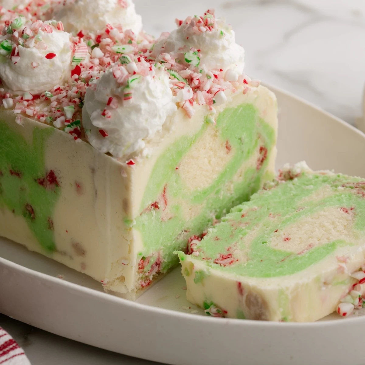 A photo of a creamy, swirled Twist Peppermint dessert, topped with crushed peppermint candies.