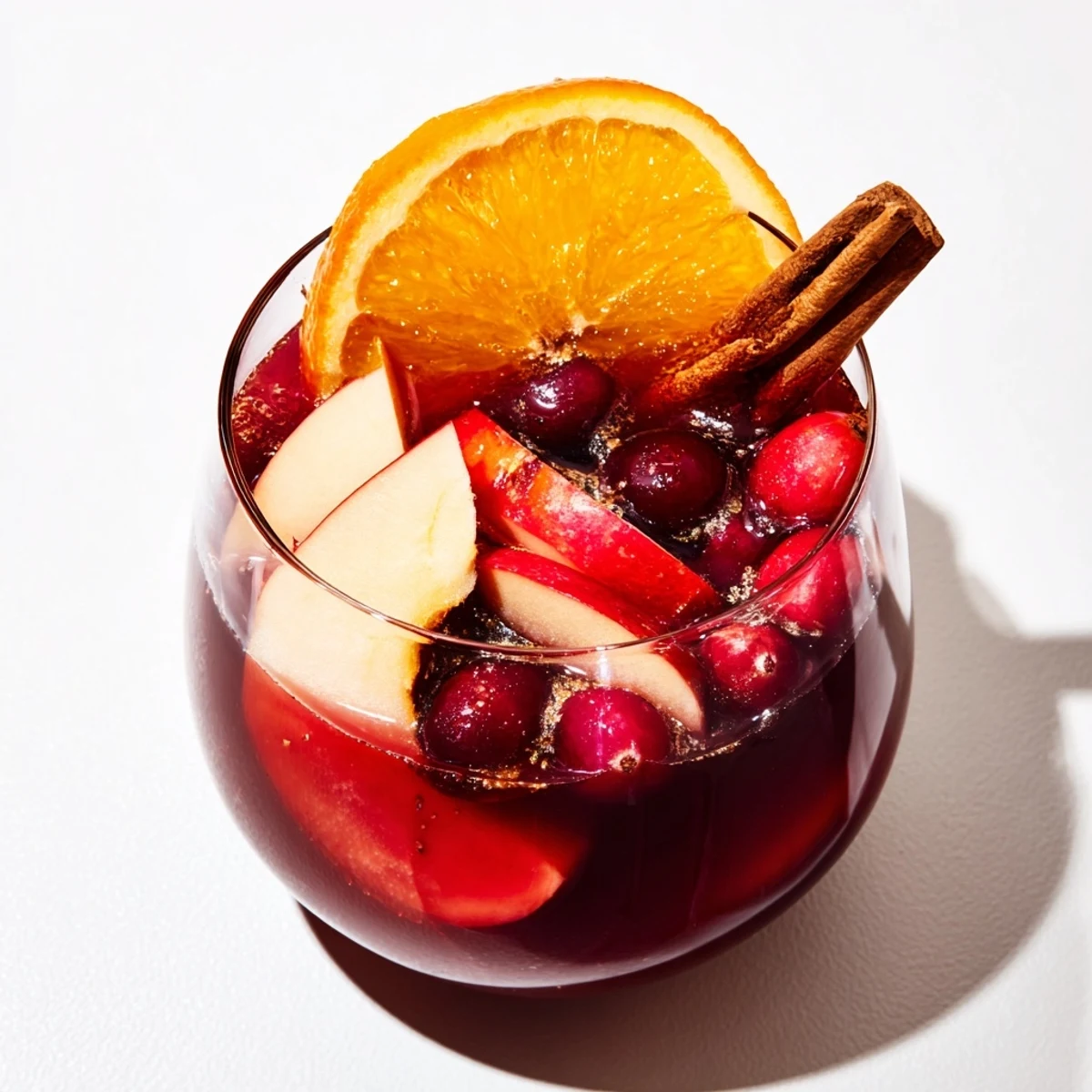 Steaming mugs of Spiced Holiday Punch, garnished with orange slices for a delightful aroma.