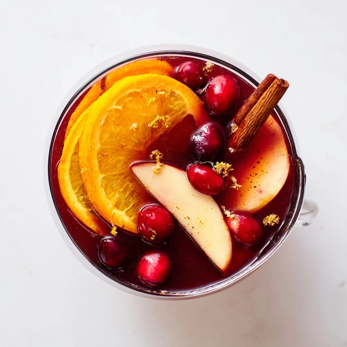 Garnished with fresh fruit, this vibrant Spiced Holiday Punch simmers with holiday spices and cheer.