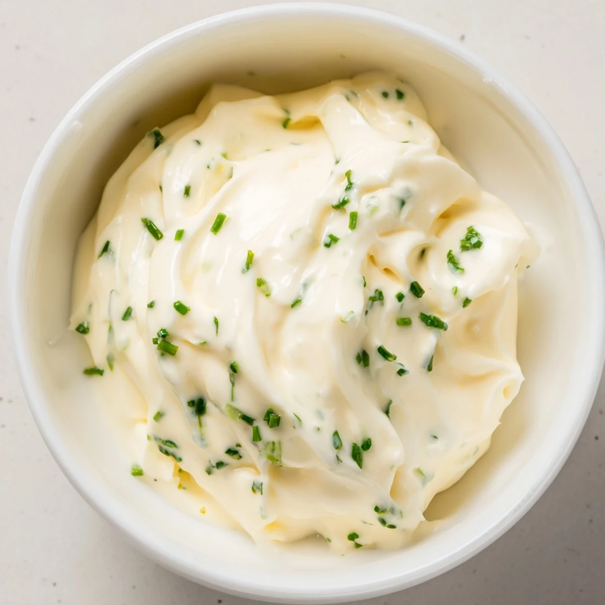 Whisked homemade Creamy Salad Dressing with a rich texture, paired with crisp lettuce and colorful vegetable crudités.