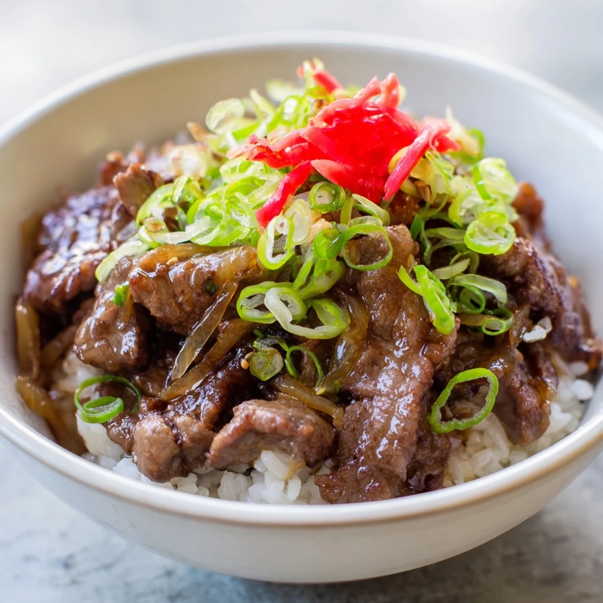 Tender sliced beef and onions in rich dashi broth served over white rice, finished with a soft egg for extra heartiness.