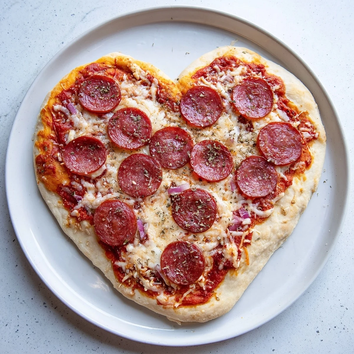 Stylized overhead shot of Heart Shaped Pepperoni Pizza on a wooden board, garnished with herbs and ready to serve for two to three people.