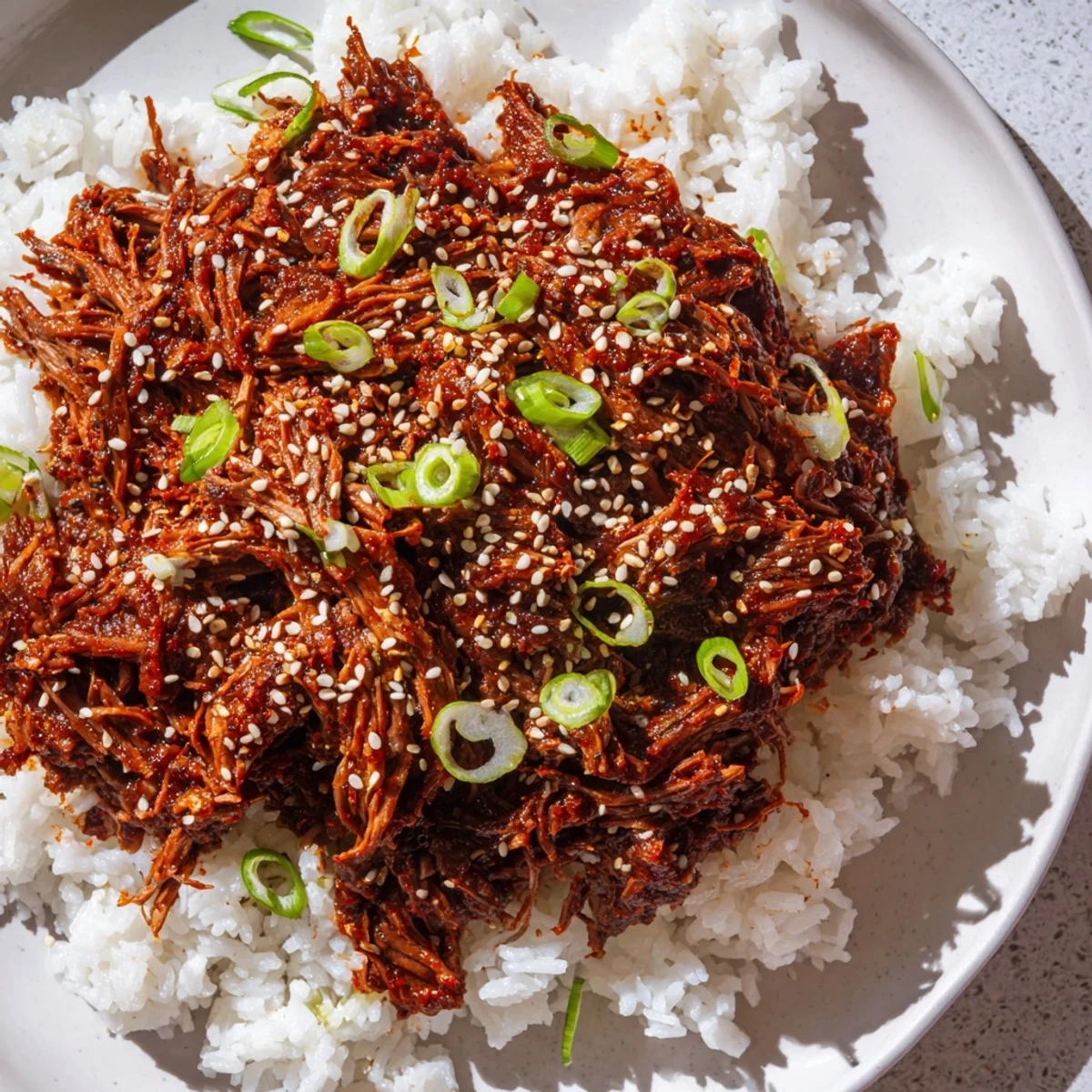 Plated in crisp lettuce wraps, Slow Cooker Korean Beef showcases juicy beef chunks coated in a glossy, savory-sweet sauce.