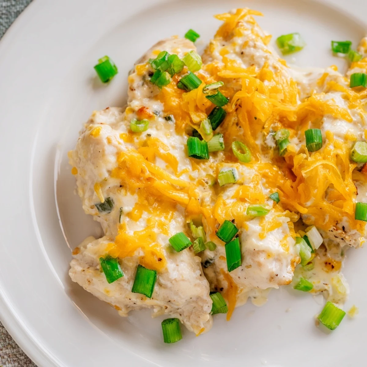 Savory Sour Cream and Onion Chicken breasts are smothered in a tangy green onion sauce, baked until tender and ready to slice.