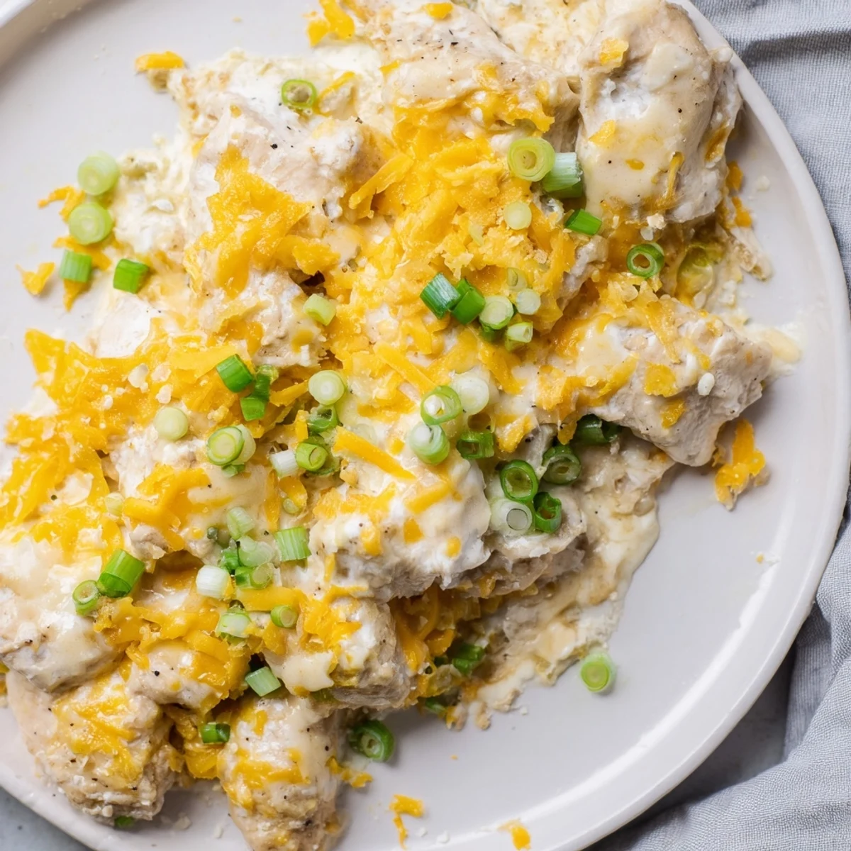 Tender chicken breasts baked in a creamy Sour Cream and Onion Chicken sauce, garnished with fresh chopped green onions for a flavorful dinner.