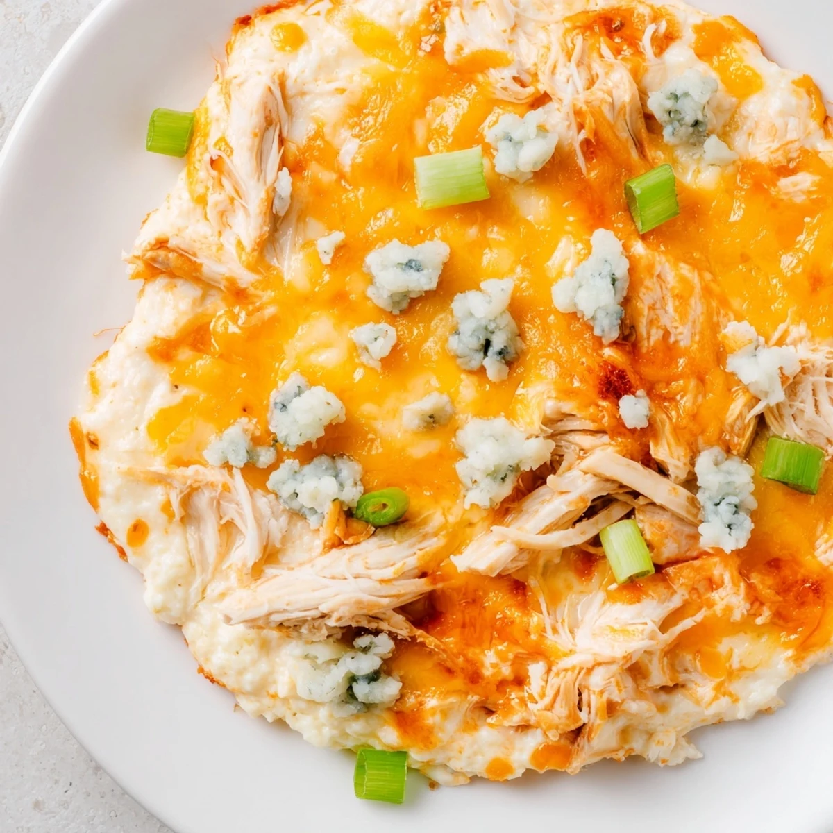 Spicy, low carb Keto Buffalo Chicken Dip in a white dish ready for game day snacking.