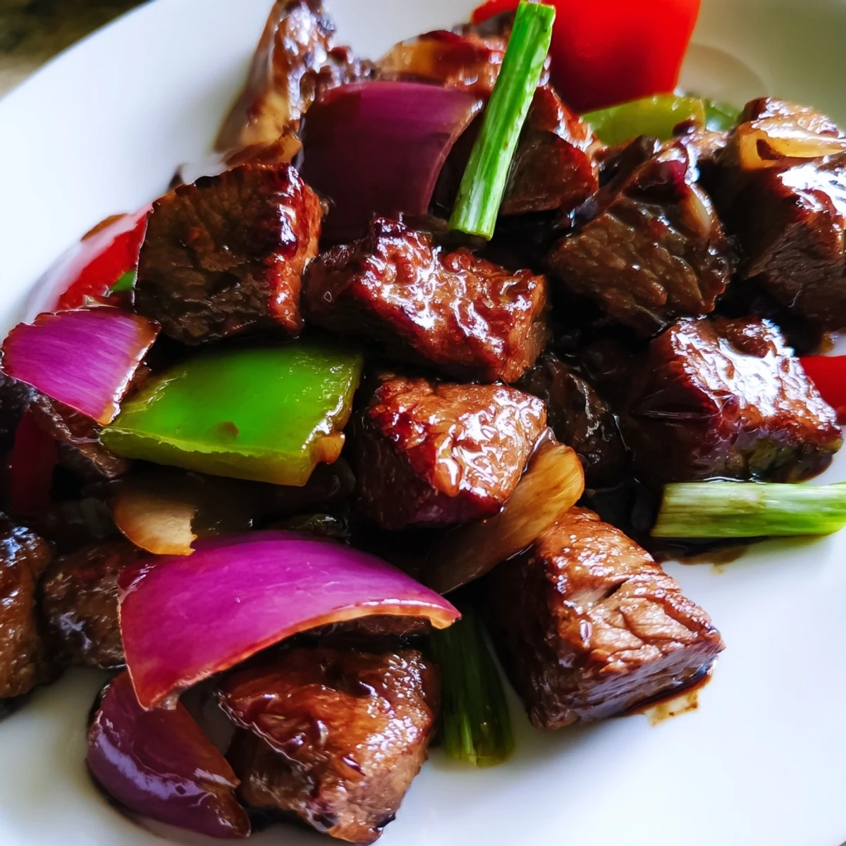 Vietnamese Shaking Beef served on fresh watercress with sliced tomatoes and a tangy lime dipping sauce.