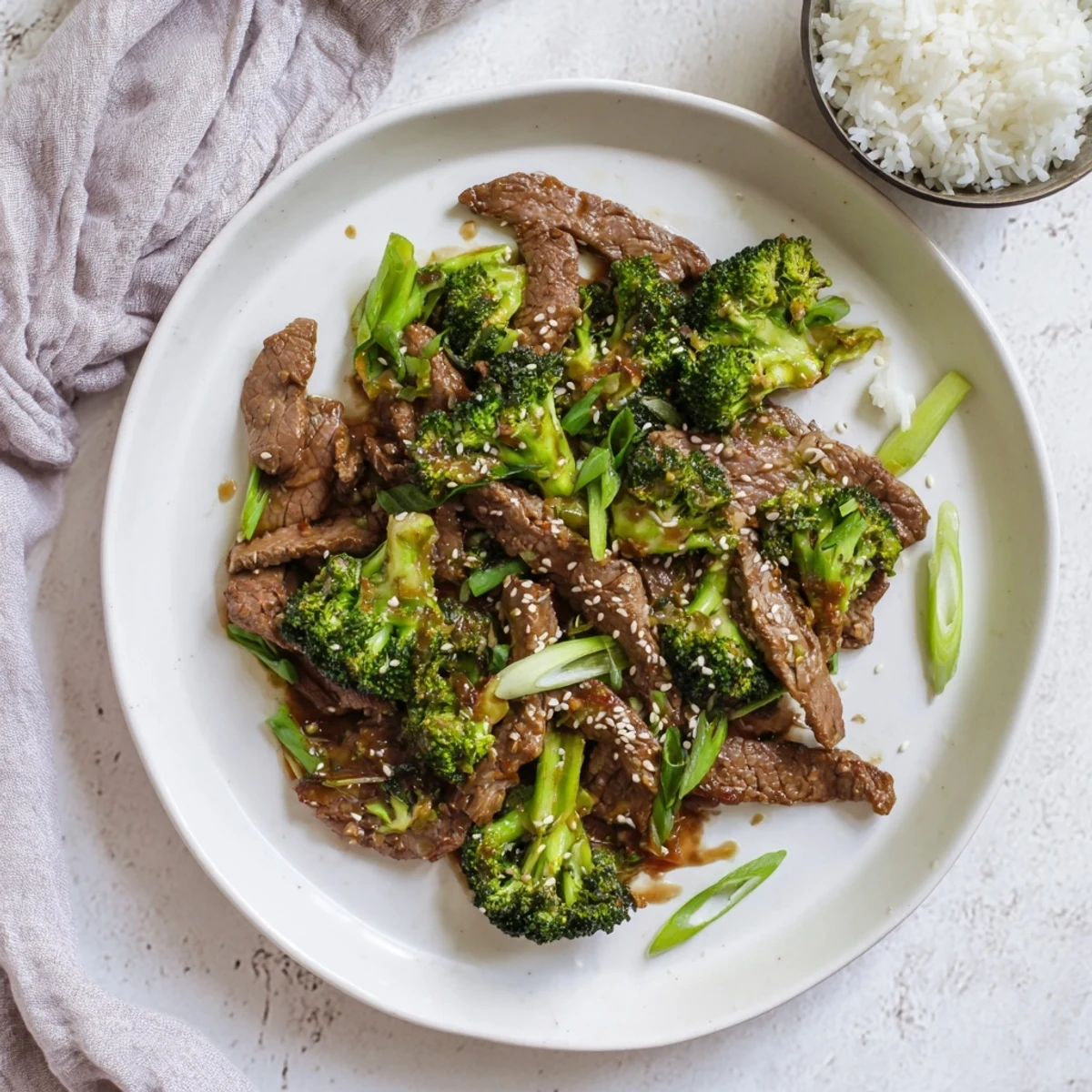 Freshly cooked Better Than Takeout Beef With Broccoli served hot over steamed rice in a white bowl, ready to enjoy.