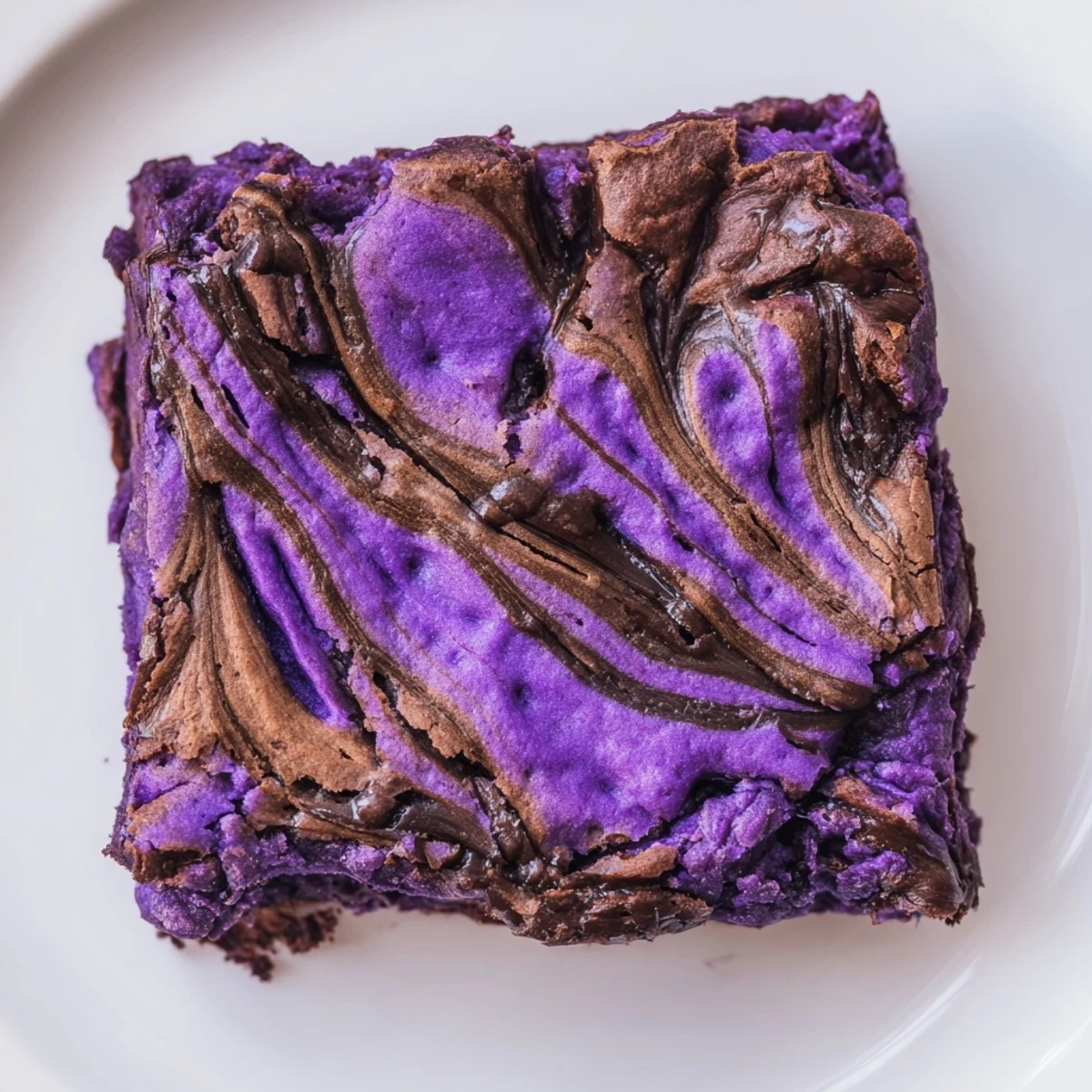 Rich Filipino purple yam brownie squares topped with marbled chocolate drizzle