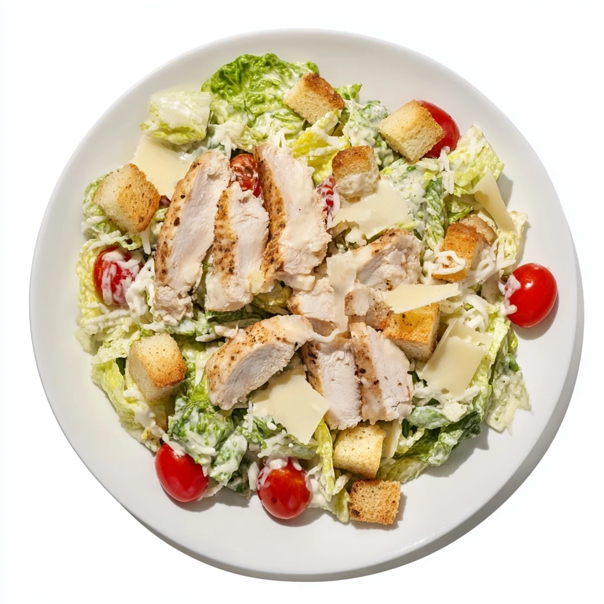 Crisp romaine lettuce topped with juicy grilled chicken slices and golden croutons in this chicken Caesar salad