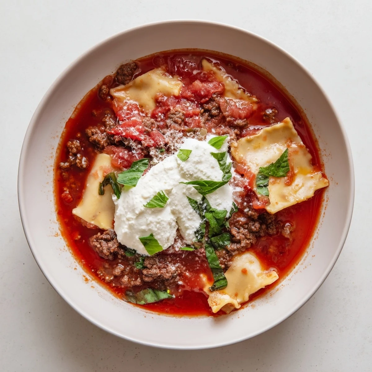 Hearty one-pot Italian lasagna soup featuring tender pasta pieces in rich tomato broth with melted mozzarella