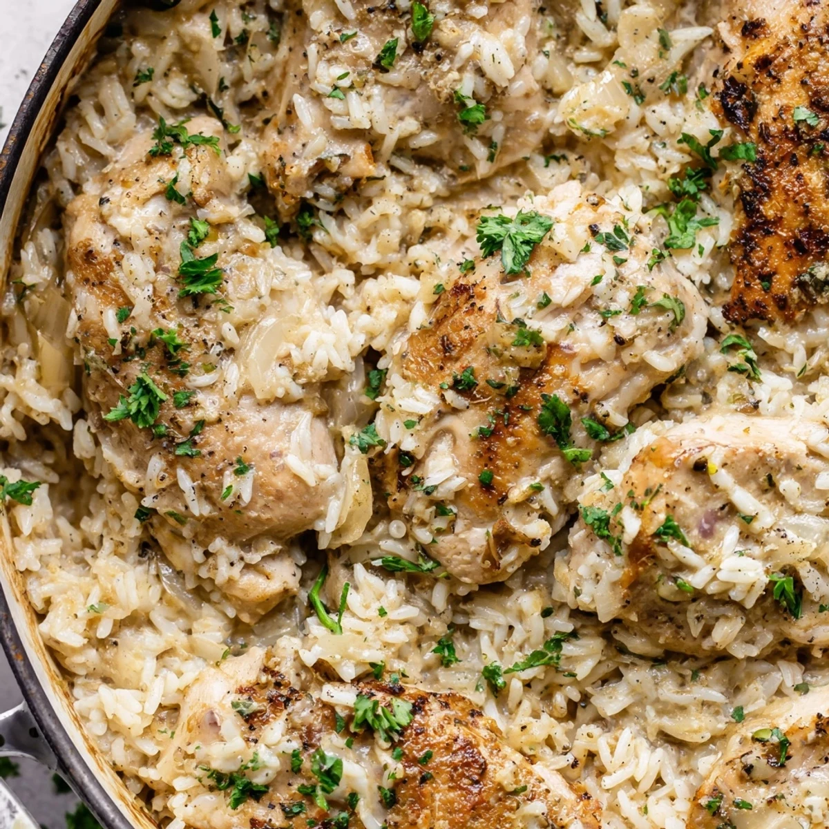 Juicy chicken breasts resting on tender rice in a rich Italian-seasoned cream sauce casserole