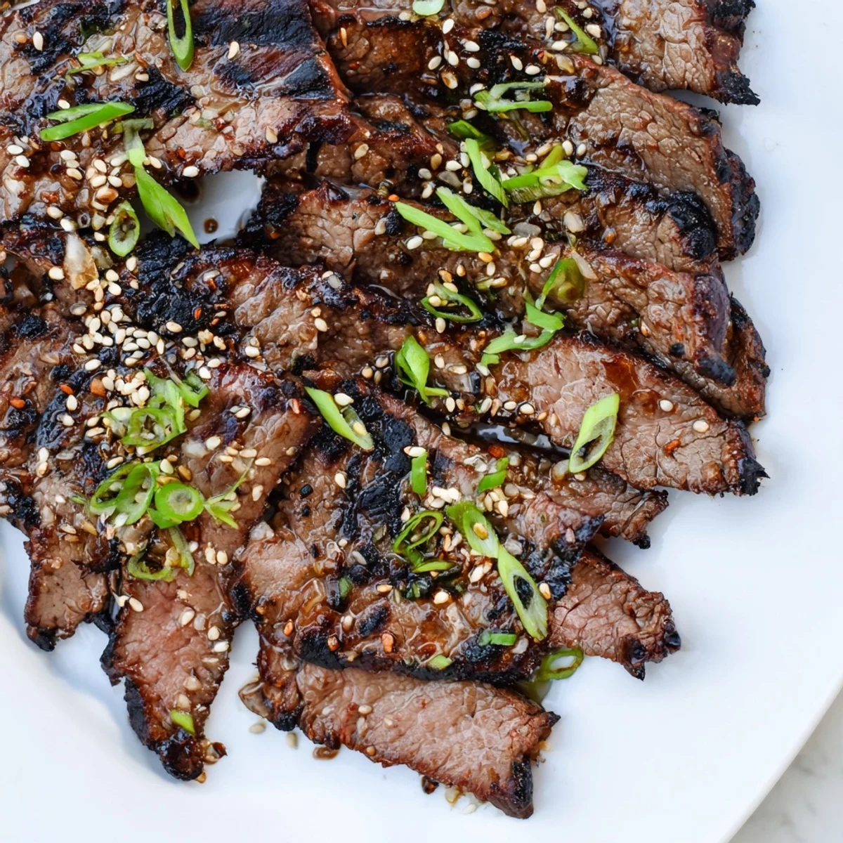 Thinly sliced Beef Yakiniku grilling to perfection with glossy marinade and colorful bell peppers