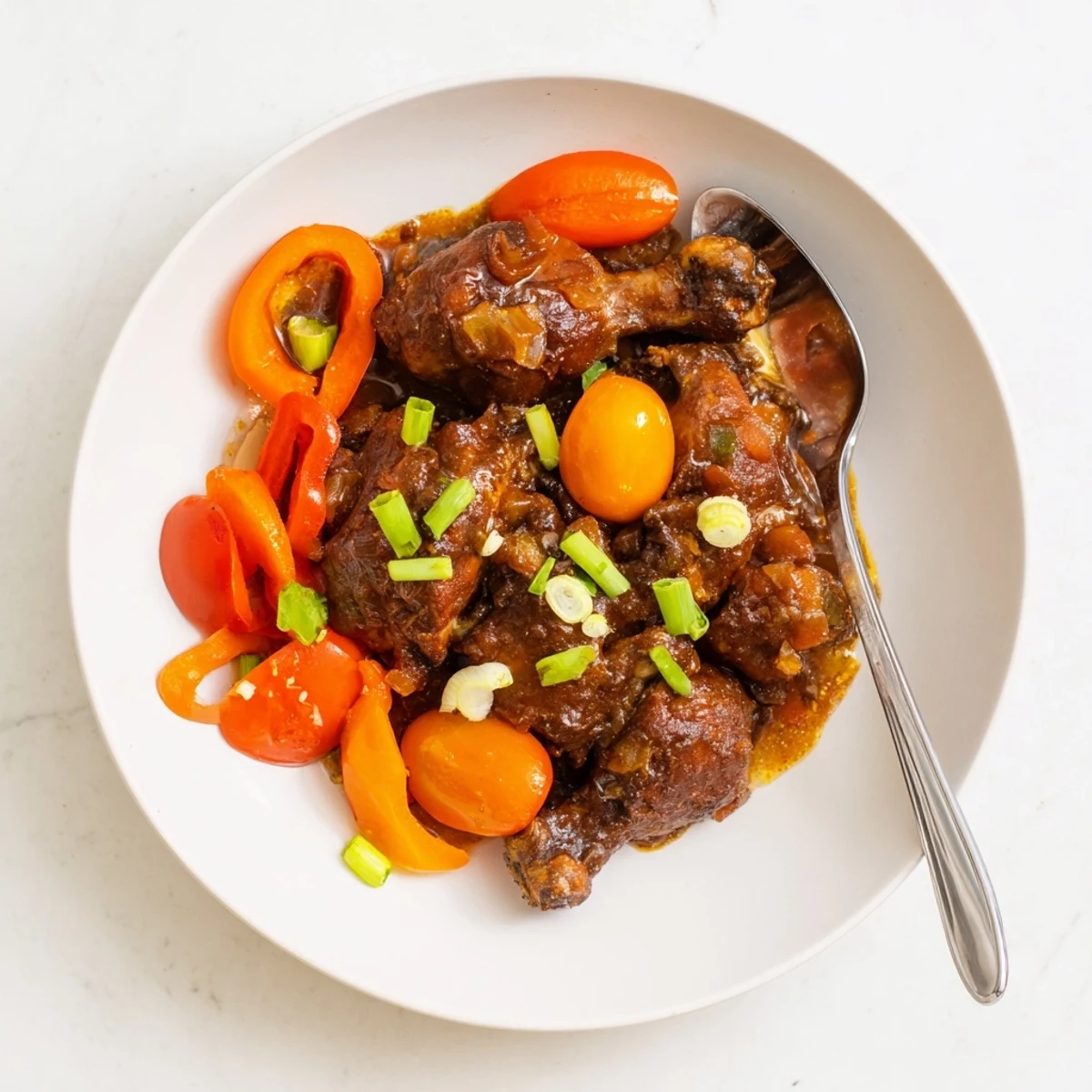 Tender Jamaican brown stew chicken simmered in a rich, deeply spiced brown gravy