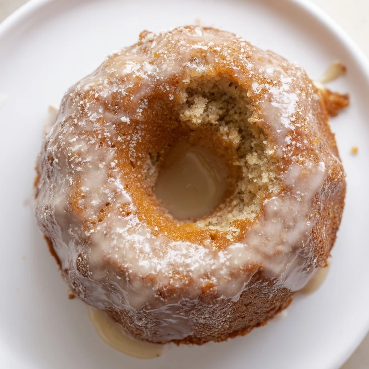 Warm Banana Donuts with golden tops, moist crumb, powdered glaze sheen