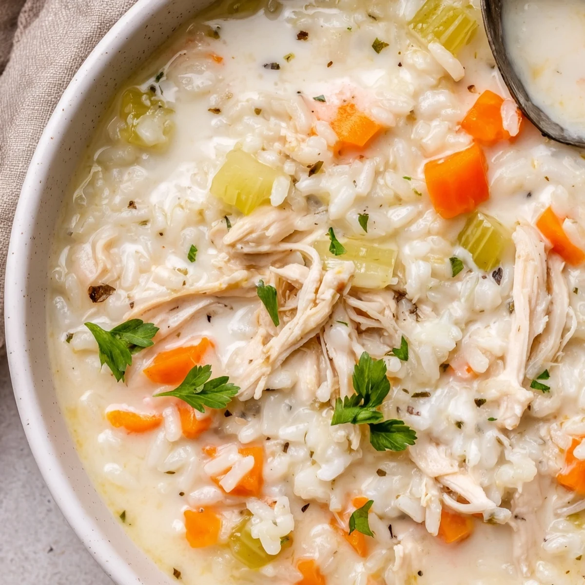 A simmering pot of Creamy Chicken Rice Soup, ready to serve hot.