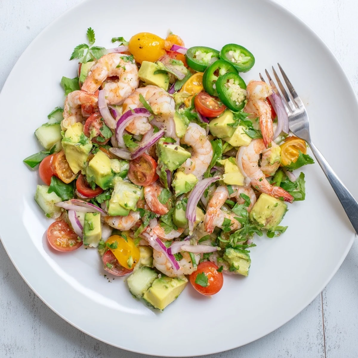 Fresh shrimp avocado salad recipe with colorful vegetables and zesty citrus dressing in bowl