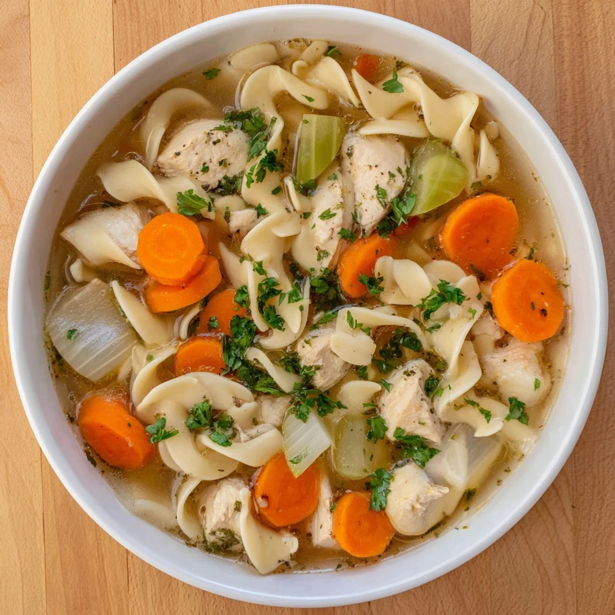 Hearty one pot chicken and noodles dish garnished with fresh green parsley