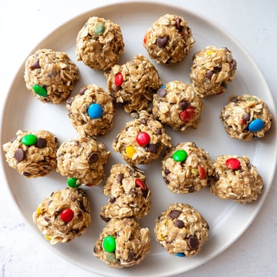 Chewy, no-bake Monster Cookie Protein Balls with chocolate chips and candy-coated chocolates for an easy American snack.