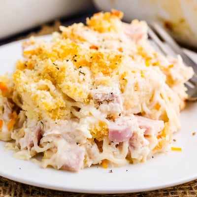 Sliced in a baking dish, Chicken Cordon Bleu Casserole Recipe served with salad