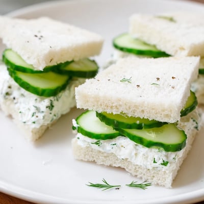 Stack of Classic Cucumber Sandwiches showing soft white bread and creamy herbed filling